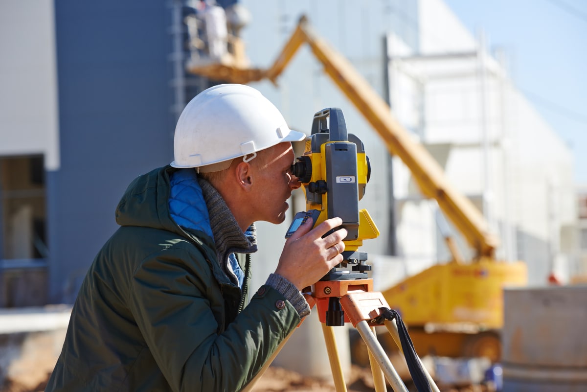 Surveyor using equipment in field
